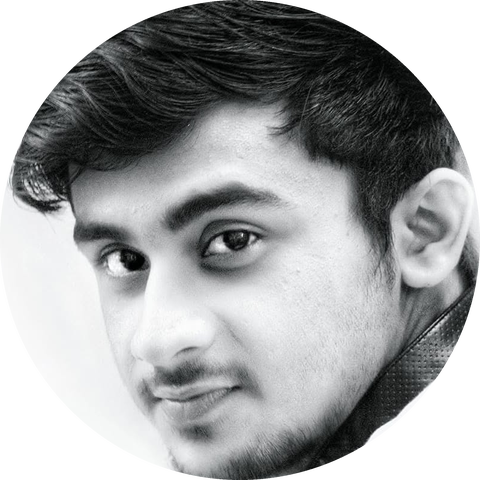 Black and white photo of Abhipriyo Banerjee looking over his shoulder
